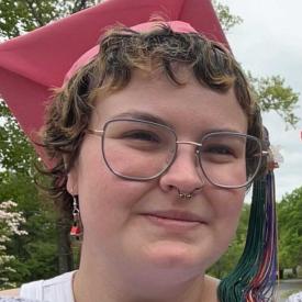 Abby Fussell wearing a red graduation cap.