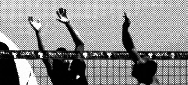 Black and white photo of people playing volleyball