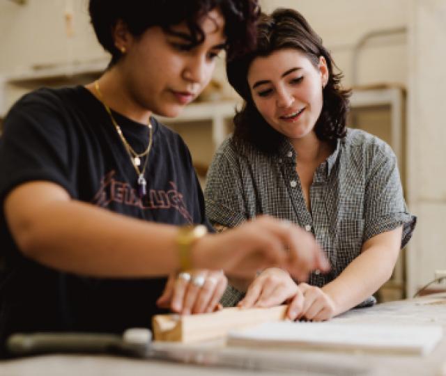 Two students work together in an art studio.