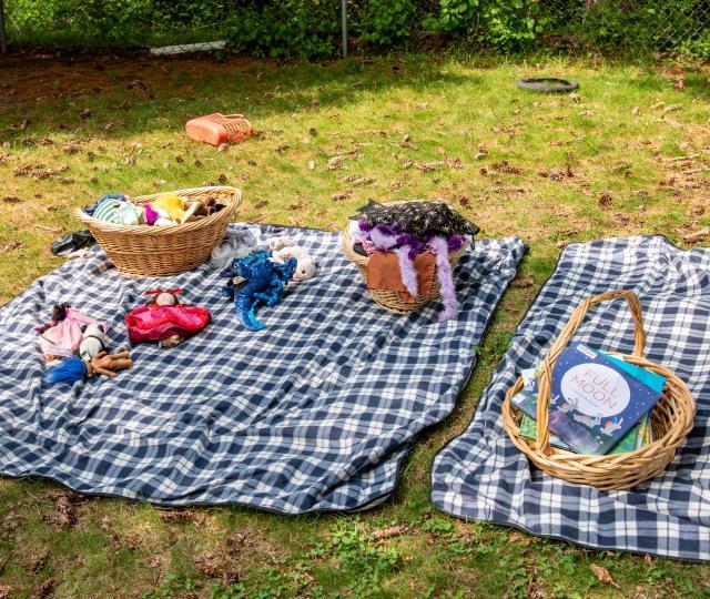 A blanket outside on the grass in the playground of the Early Learning Center.