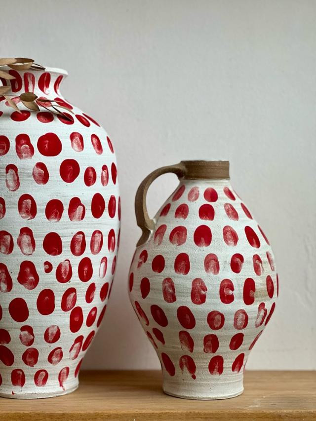 Lucas Mays's pottery with red fingerprint dots