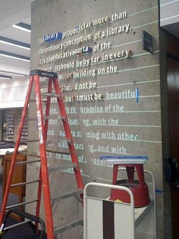 Wall with lettering and a ladder