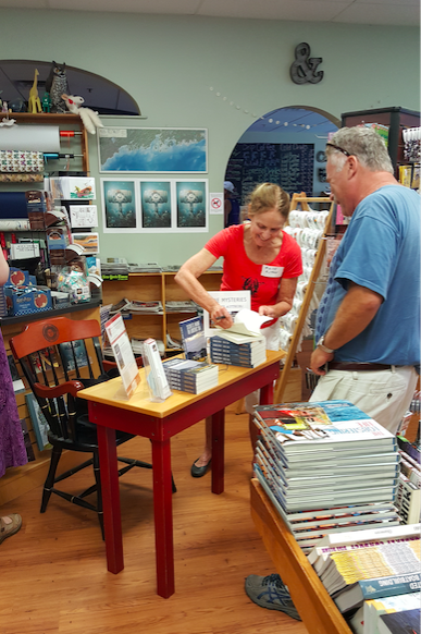 Charlene D'Avanzo signing her books.