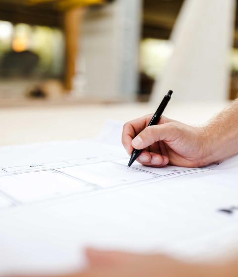 White paper being written on in black pen by hand.